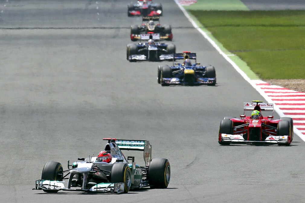 Michael Schumacher (L) of Mercedes AMG steers his car during the 2012 Great Britain Formula One Grand Prix at the Silverstone