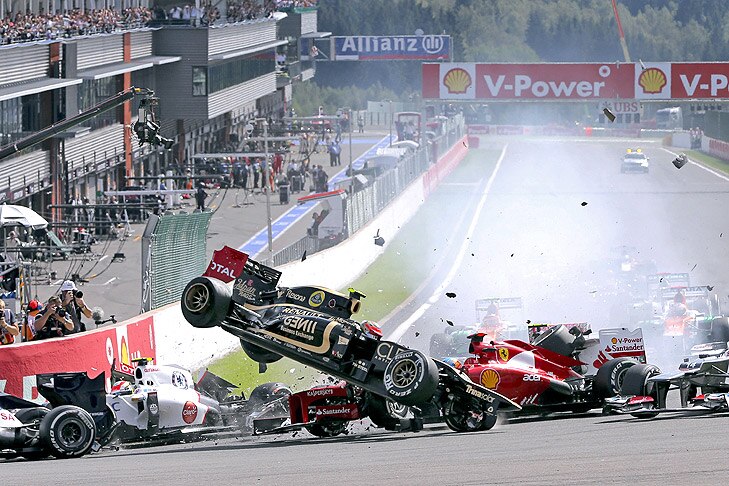 French Formula One driver Romain Grosjean (C) of Lotus crashes during the start of the 2012 Belgium Formula One Grand Prix at the Spa-Francorchamps race track near Francorchamps