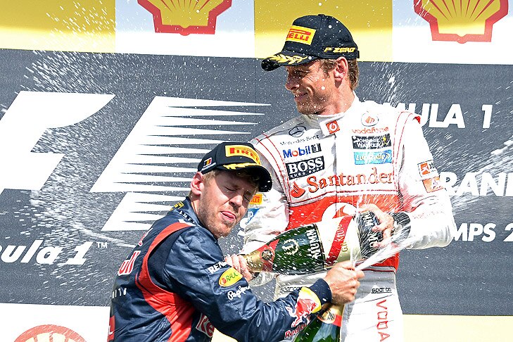 Winner British Formula One driver Jenson Button (R) of McLaren Mercedes and 2nd German Sebastian Vettel of Red Bull celebrate with champagne at the podium after the 2012 Belgium Formula One Grand Prix