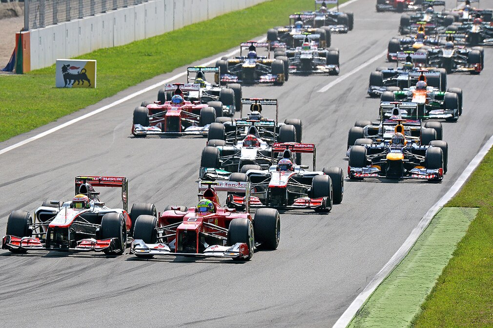 Brazilian Formula One driver Felipe Massa (R) of Ferrari and British Formula One driver Lewis Hamilton (L) of McLaren Mercedes lead the pack during the start of the 2012 Italian Formula One Grand Prix