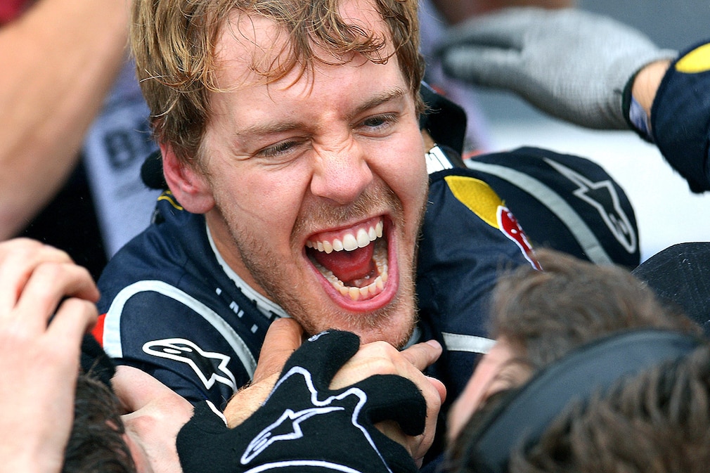 German Formula One driver Sebastian Vettel of Red Bull celebrates his third world championship in a row after the Formula One Grand Prix of Brazil