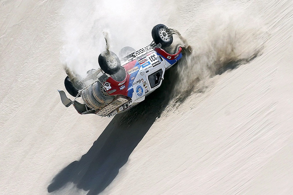 Russian driver Vladimir Vasilyev overturns with his vehicle during the third stage of the Rally Dakar 2013 at the Nasca desert, about 450km south of Lima, Peru