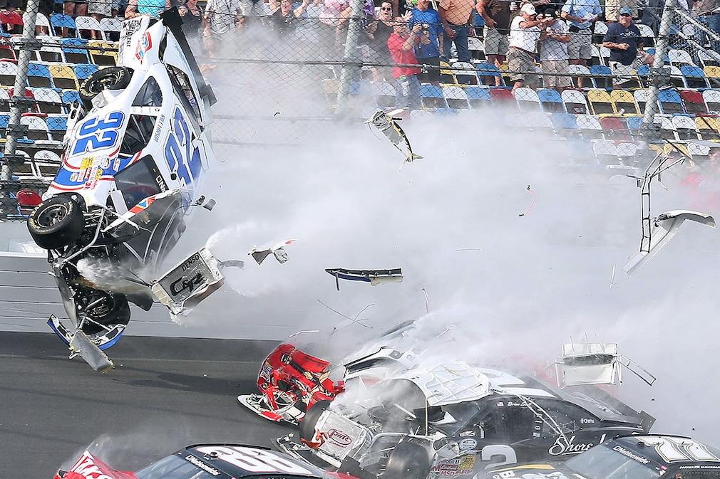 A spectacular crash involving the car of Kyle Larson (32) takes place the last lap of the DRIVE4COPD 300 Nationwide Series race at Daytona International Speedway in Daytona