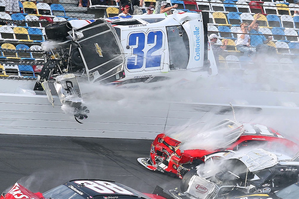 A spectacular crash involving the car of Kyle Larson (32) takes place the last lap of the DRIVE4COPD 300 Nationwide Series race at Daytona International Speedway in Daytona