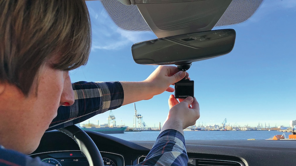 Readakteur bringt Dashcam an der Windschutzscheibe an.