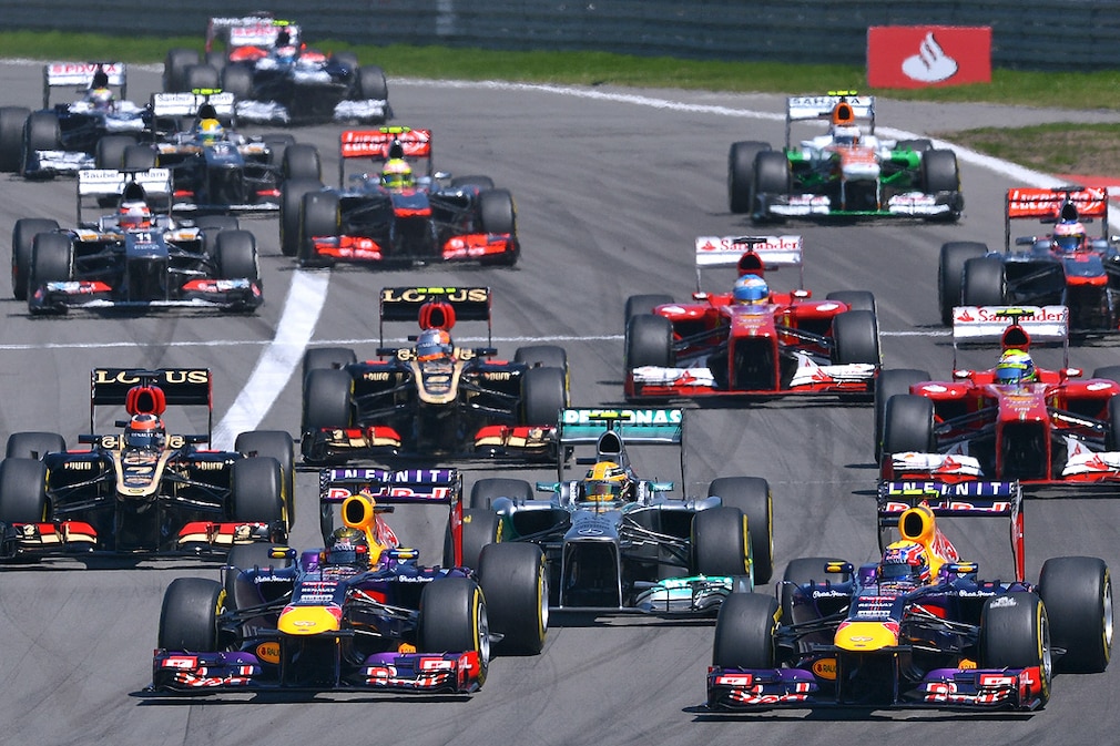 German Formula One driver Sebastian Vettel of Red Bull (L front) and his Australian team mate Mark Webber (R) lead the pack ahead of British Lewis Hamilton of Mercedes AMG (C) after the start of the Grand Prix of Germany at the Nuerburgring race track