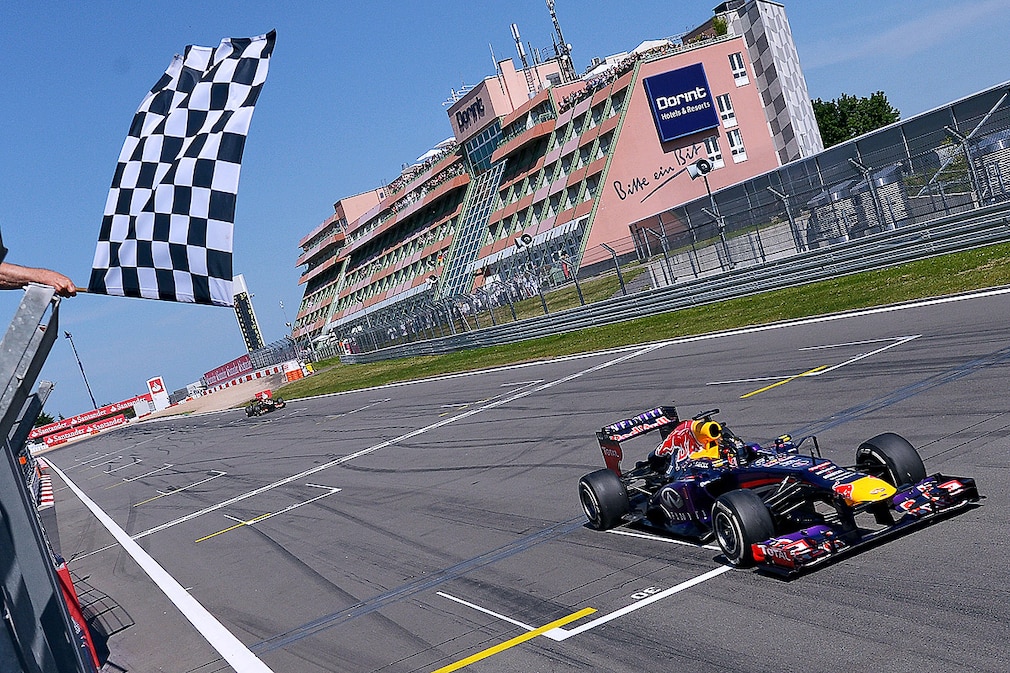 German Formula One driver Sebastian Vettel of Red Bull crosses the chequered flag to win the Grand Prix of Germany at the Nuerburgring