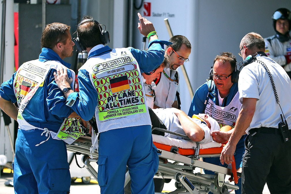 cameraman receives medical treatment on a stretcher after beeing hit by tire of the Australian Formula One driver Mark Webber of Red Bull Racing car during the Formula One Grand Prix of Germany at the Nuerburgring
