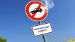 Symbolbild: Straße mit Verbotsschild für Verbrennungsmotoren mit austretendem Qualm