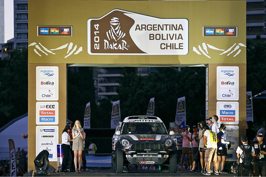 French Stephane Peterhansel and Jean Paul Cottret at the start podium during the official presentation of Rally Dakar 2014 in Rosario, Argentina