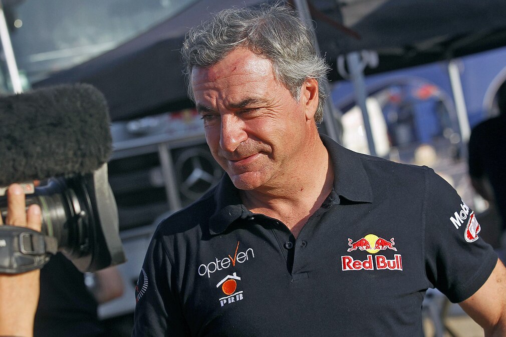 Spanish Carlos Sainz talks to media after he quit the competition due to an accident suffered during the tenth stage of the Dakar Rally 2014