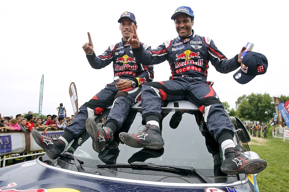 Qatari pilot Nasser Al-Attiyah (R) and his French copilot Matthieu Baumel (L) celebrate their victory after the last stage of the 2015 Rally Dakar, between Rosario and Buenos Aires