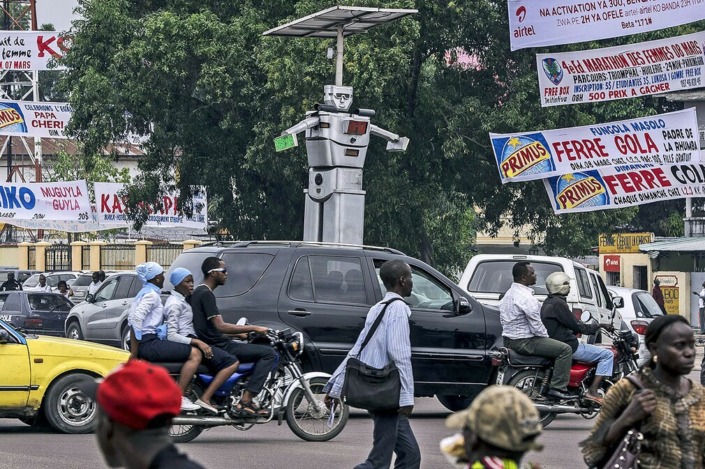 A newly installed solar powered Robtocop looks down over road users in Kinshasa Kongo