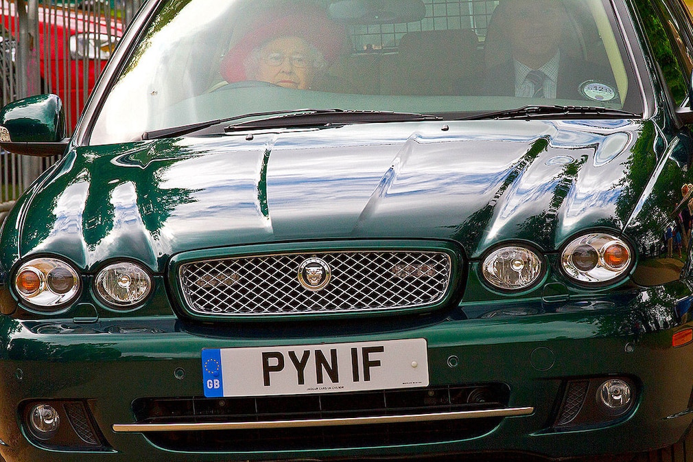 Britain's Queen Elizabeth II leaves in a car driven by herself for the Cartier Queen's Cup Final at Guards Polo Club in Egham, 16 June 2013.