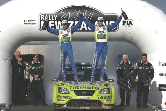 Marcus Grönholm und Beifahrer Timo Rautiainen feiern den knappsten Sieg der WRC-Geschichte.
