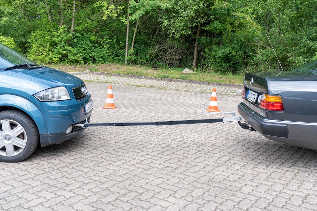 Abschleppstange befestigt zwischen zwei Fahrzeugen mit deutlich sichtbarer, roter Markierungsfahne