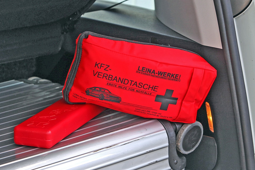 Verbandkasten und Warndreieck immer auf oder neben das Gepäck legen