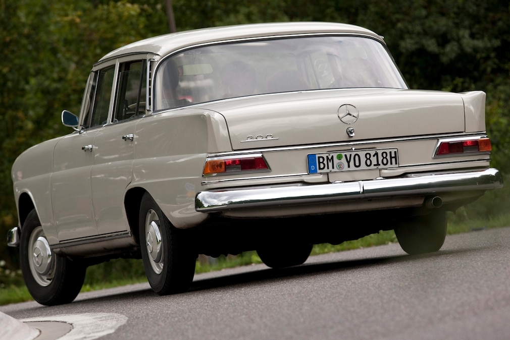 Mercedes 200 W 110 "Heckflosse" fahrend schräg von hinten