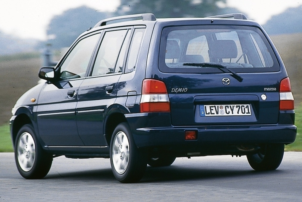 Mazda Demio fahrend schräg von hinten