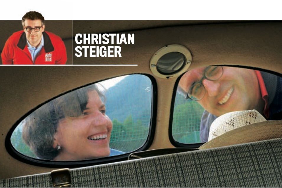 AUTO BILD-Redakteur Christian Steiger durchs Heckfenster dses VW Käfer aufgenommen