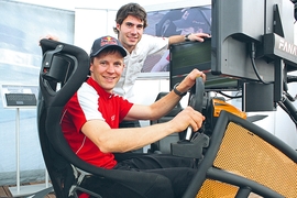 Audi Werksfahrer Mattias Ekström (vorn) und sein Kollege Miguel Molina am DTM Simulator am Norisring
